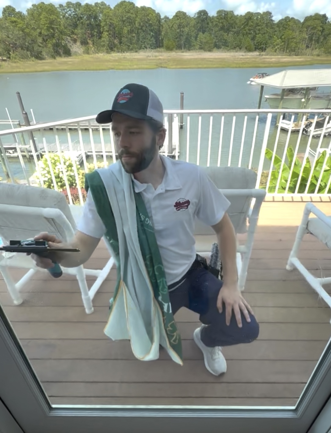 Blooms technician squeegeeing a large window on a Gulf Coast waterfront home